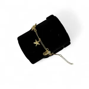 TORNOZELEIRA ELO GRUMET COM PENDURICALHO ESTRELA DO MAR, CONCHA, RABO DE BALEIA, TARTARUGA E PÉROLA COM EXTENSOR - BANHADO A OURO 18K