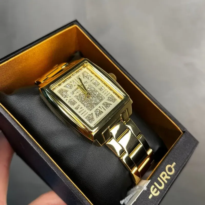 RELÓGIO EURO FEMININO DOURADO COM GLITER INTERIOR E NUMEROS ROMANOS  EU2033BXJ4X- COR DOURADA RELÓGIO EURO FEMININO DOURADO COM GLITER INTERIOR E NUMEROS ROMANOS  EU2033BXJ4X- COR DOURADA