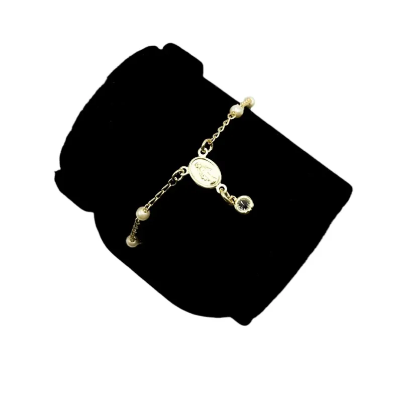 PULSEIRA TERÇO COM PÉROLAS E PONTO DE LUZ PENDURADO  - BANHADO A OURO 18K PULSEIRA TERÇO COM PÉROLAS E PONTO DE LUZ PENDURADO  - BANHADO A OURO 18K