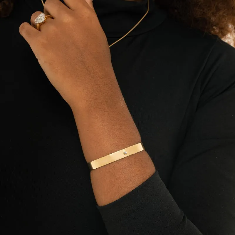 BRACELETE LISO GROSSO COM UMA PEDRA CENTRAL CRAVEJADA  - BANHADO A OURO 18K